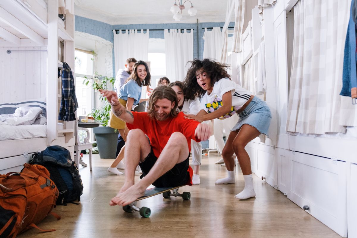 A group of friends enjoying playful moments indoors, showcasing youthful spirit and camaraderie.