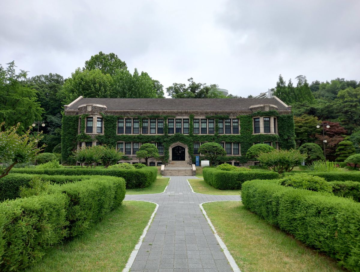 Historic building with ivy facade surrounded by lush greenery in Seoul, South Korea.