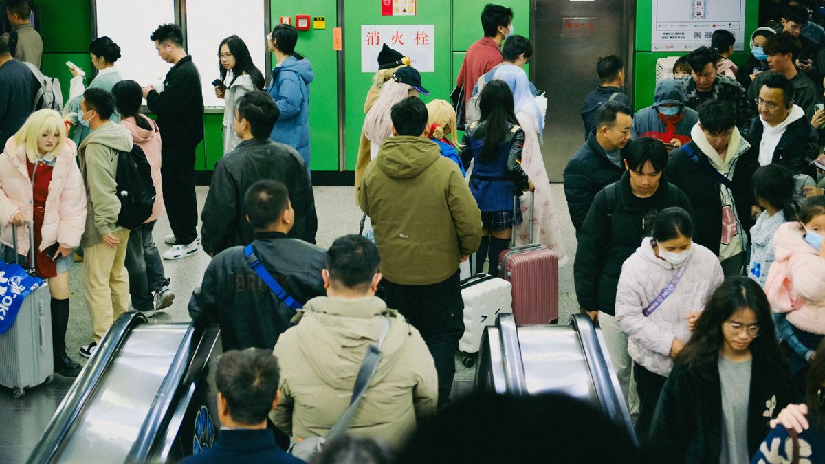 A busy subway station filled with people, showcasing urban diversity and commuter life.