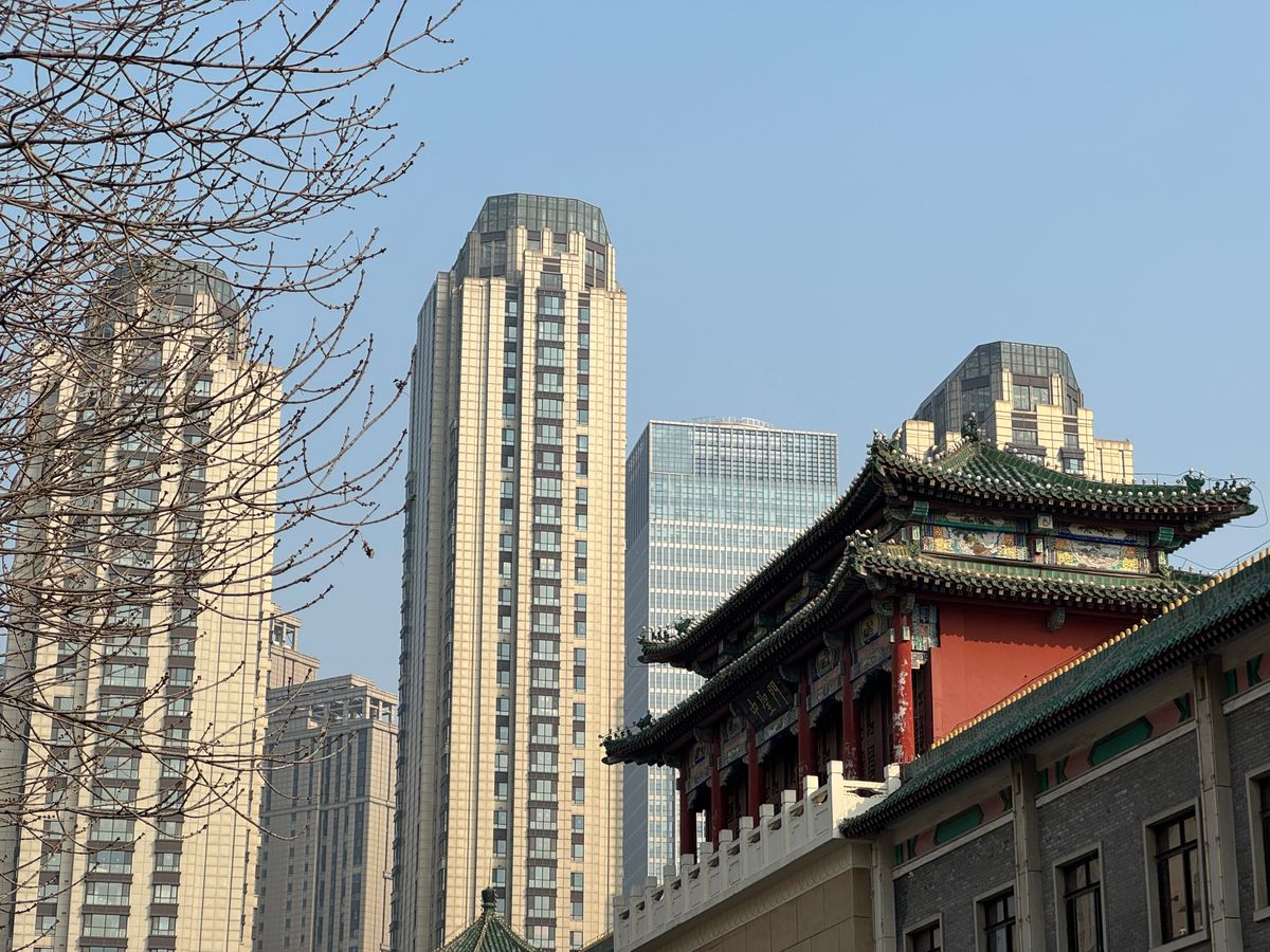 A blend of traditional Chinese architecture and modern skyscrapers in Tianjin, China.