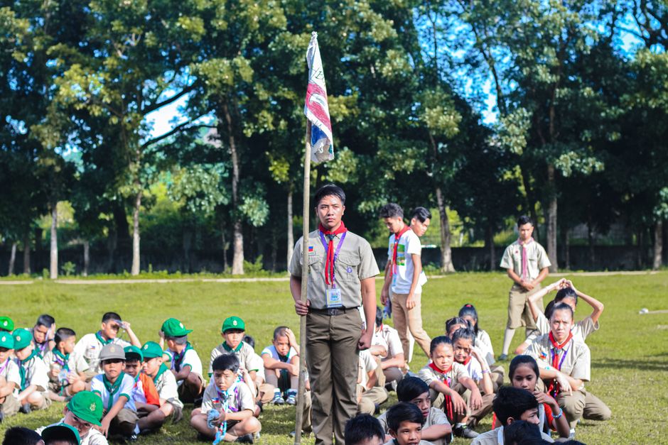 Group of students receiving certificates outdoors, highlighting achievement.